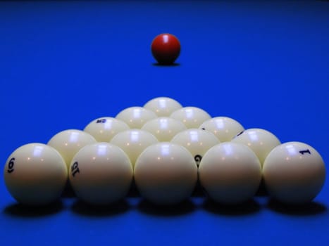 Billiard spheres are built and await the beginnings of the game of chance in the dark-blue field.