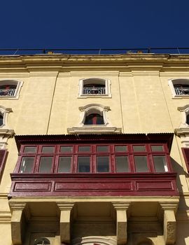 A medieval wooden balcony in traditional baroque style in Valletta in Malta