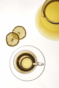 Tea pot with cup and lemon