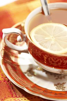 red cup of tea with lemon