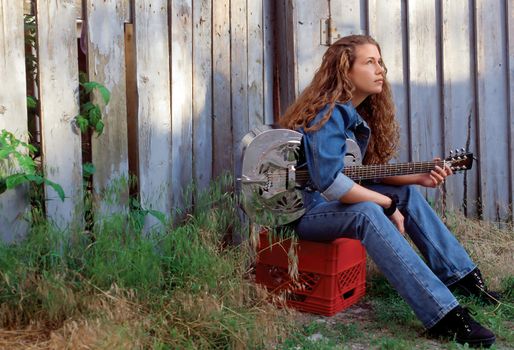 A beautiful country singer thinking about her songwriting.  
