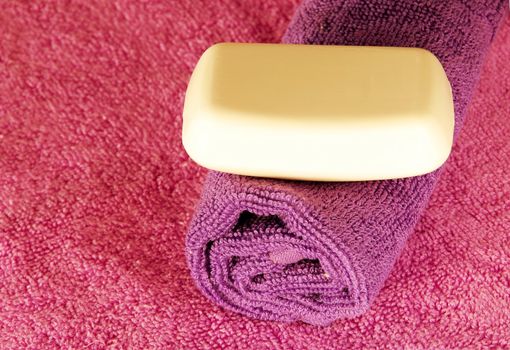 magenta and purple towels with white soap bar