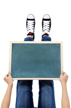 Holding a blackboard over feet on white background.