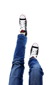 In jeans and sneakers over white background.
