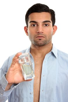 Semi dressed handsome metrosexual man holding a bottle of perfume cologne or aftershave EDT.