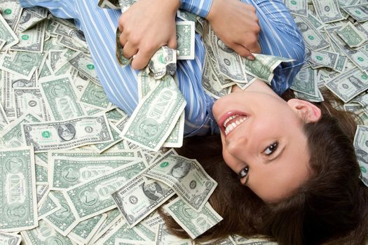 Beautiful woman laying in money