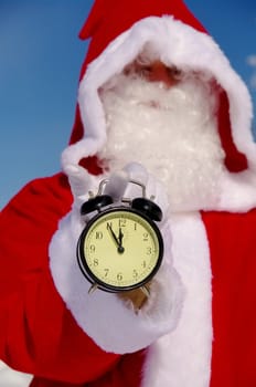 Santa Claus, Father Christmas holds watch clock