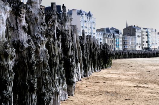 Old breakwater woods to protect the city of Saint-Malo in Brittany, France from the stormy sea.