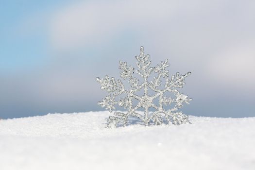 beautiful silver snowflake in snow