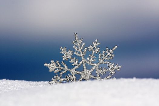 beautiful silver snowflake in snow