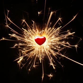 burning sparkler in the shape of a heart