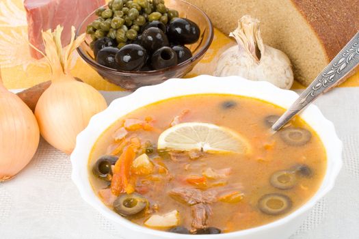 close-up meat soup with lemon, isolated on white