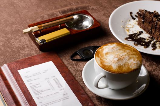 check, ashtray, cigar, lighter and coffee at restaurant table