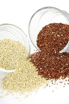 Red and white quinoa grain in glass bowls on white background