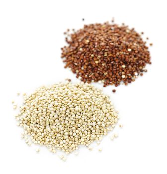 Piles of white and red quinoa grain on white background