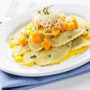Gourmet squash ravioli dinner served with cheese on plate