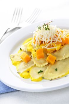 Gourmet squash ravioli dinner served with cheese on plate