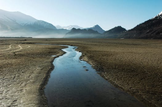 Landscape of a stream in the dried fields