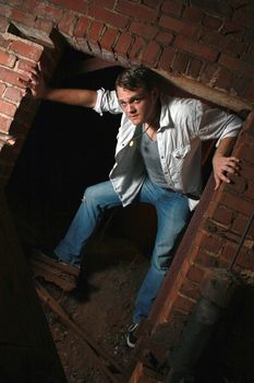 A man standing in an old brick opening