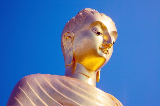 buddha - a golden head against a blue sky Buddastatue
