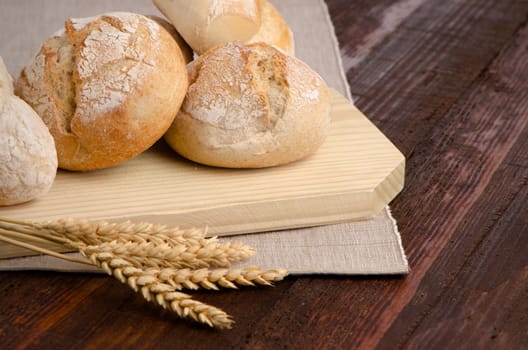 Baked bread on wood table, food concept background.