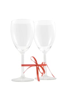 two empty glasses bounded with red ribbon