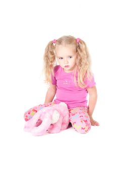 Little cute girl in pink and with ponytails in studio