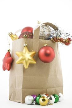 Christmas items in shopping  bag on white background