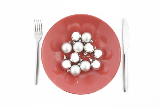 red plate with Christmas silver ball on white background