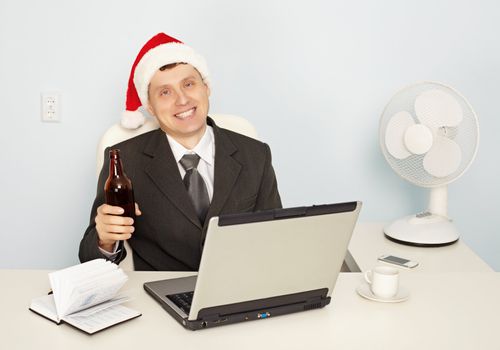 A young businessman gets drunk at the office before the new year