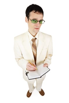 Young businessman in the light suit writes important things in the notebook