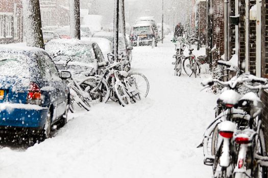 Snow in the city - streetview with bikes during snowstorm - horizontal