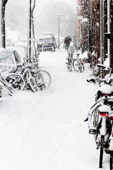 Snow in the city - streetview with bikes during snowstorm - vertical