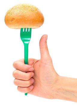 Hand holding a bun on the fork isolated on the white background