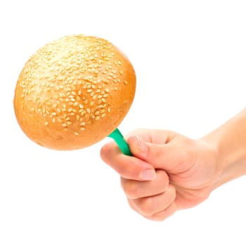 Hand holding a bun on the fork isolated on the white background