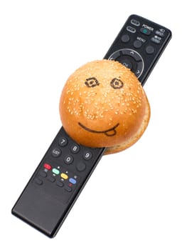 Smiley burger with TV remote control isolated on the white background
