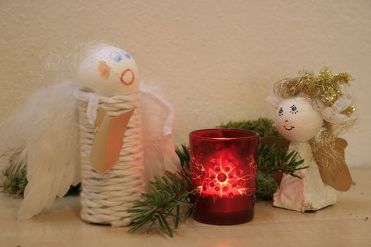 two christmas angles, candle, christmas ceiling, pine braches, moss