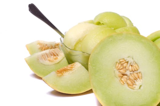 Close view of some sliced rock melon to serve as a fresh dessert isolated on a white background.