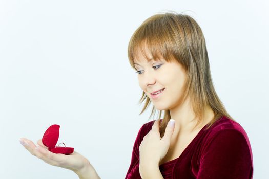 young girl with a box for rings on a light background
