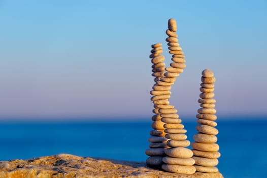 Three pile of pebbles in the balance on the seacoast