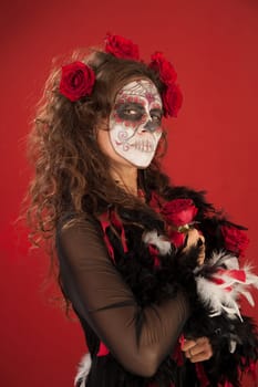 A beutiful woman holding roses and wearing zombie makeup for All Souls Day