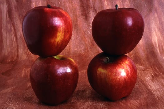 Four Red apples isolated on painted background