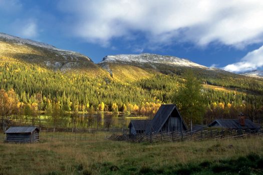 Old house by the lake in mountain in autumn