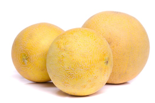 Close up view of three honeydew melons isolated on a white background.