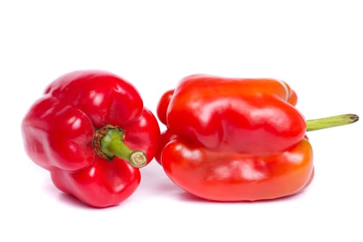 Close up view of two fresh red bell pepper isolated on a white background.