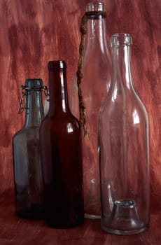 Empty bottles isolated on painted background