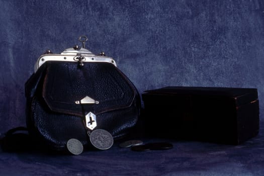 Old handbag and box isolated on painted background