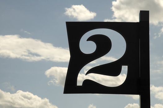 number two sign on blue cloudy sky