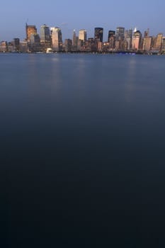 manhattan skyscrapers, hudson river in foreground, calm water, can be used as background
