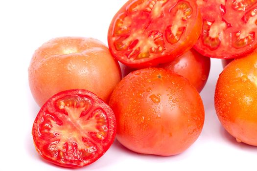Close up view of some fresh red tomato isolated on a white background.